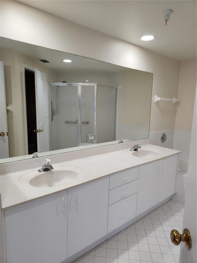 bathroom with vanity, a shower with shower door, and tile patterned flooring