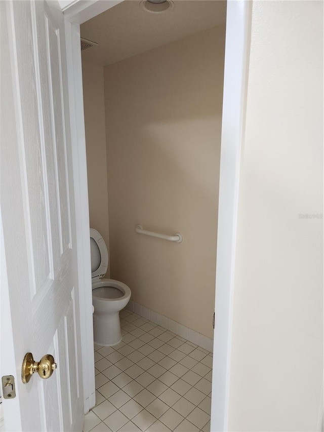 bathroom featuring toilet and tile patterned flooring