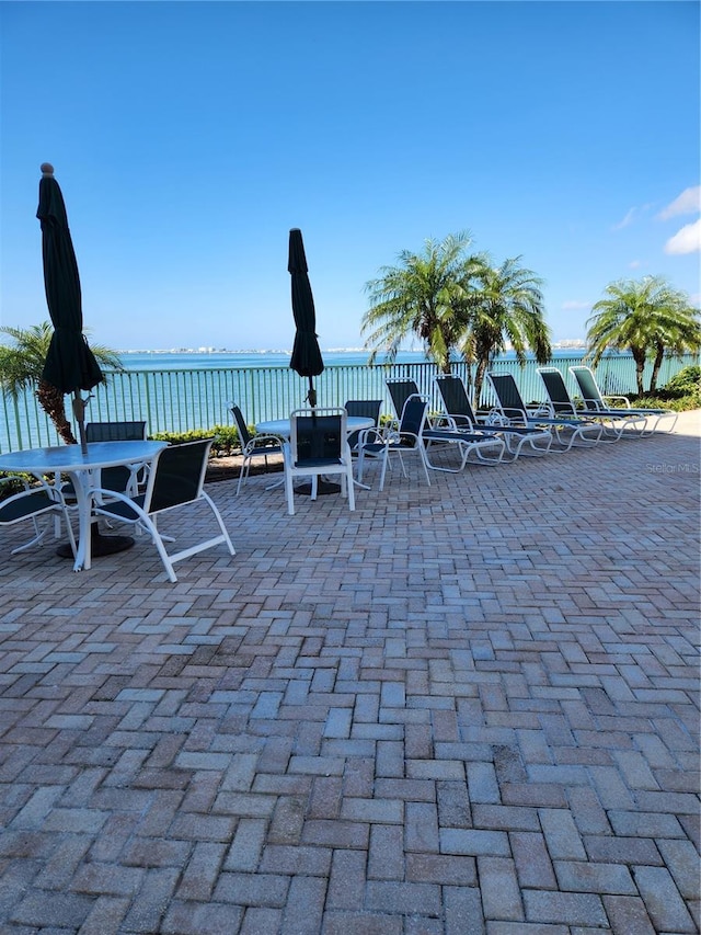 view of patio with a water view