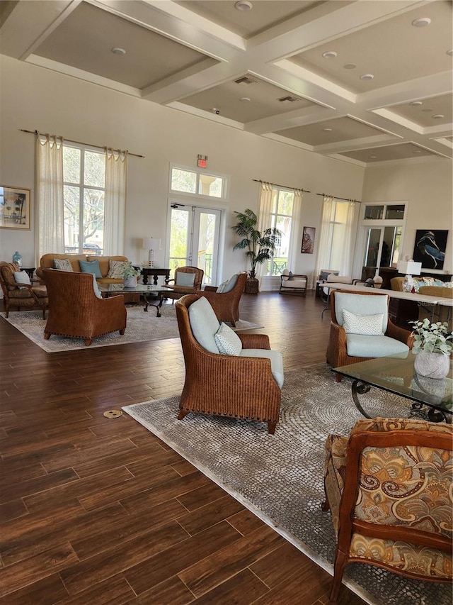 living room with beamed ceiling, coffered ceiling, and dark wood-type flooring