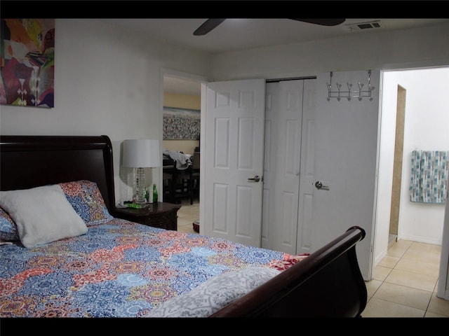 tiled bedroom with a closet and ceiling fan