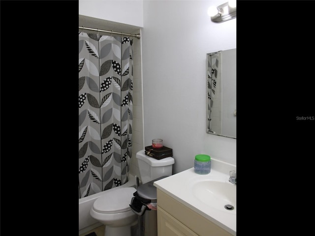 full bathroom featuring vanity, shower / tub combo, and toilet