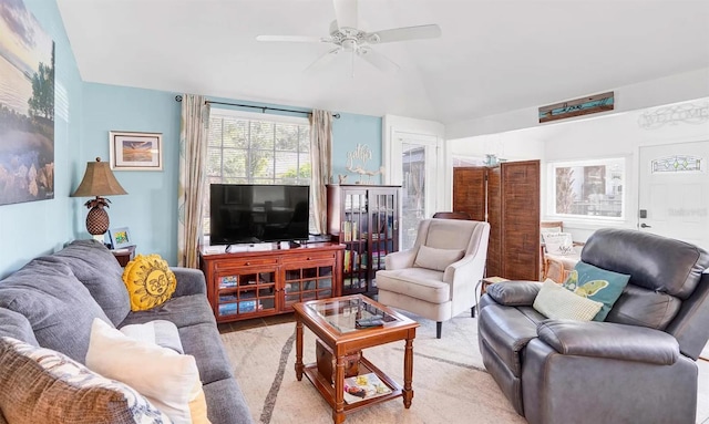 living room with ceiling fan and vaulted ceiling