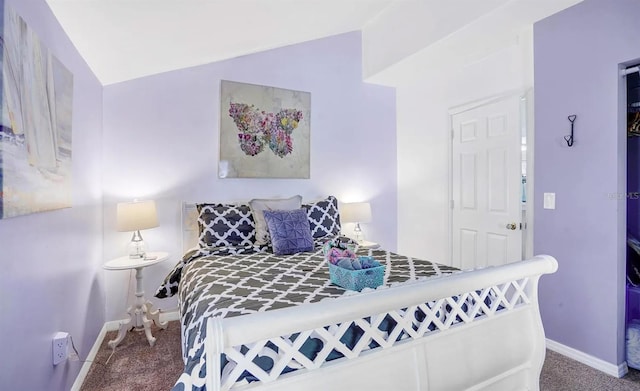 bedroom featuring lofted ceiling and carpet flooring