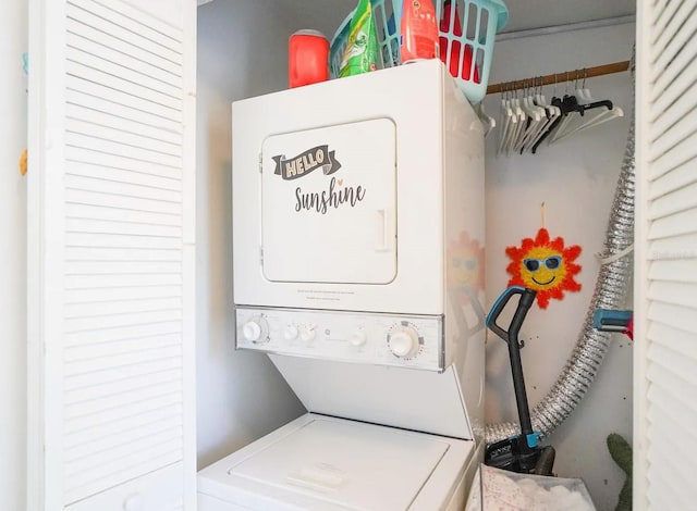 washroom featuring stacked washer / drying machine