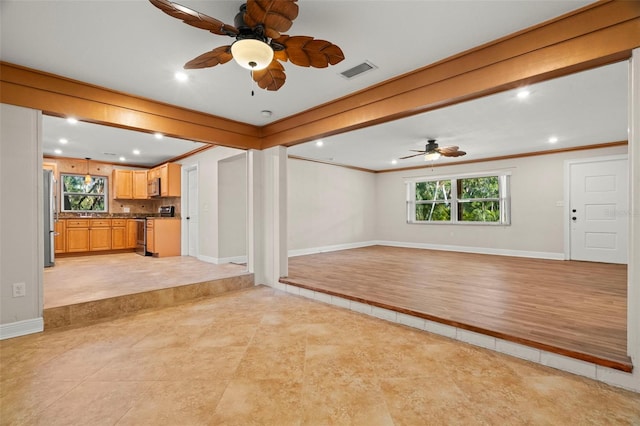 unfurnished living room featuring crown molding, ceiling fan, and light tile patterned flooring