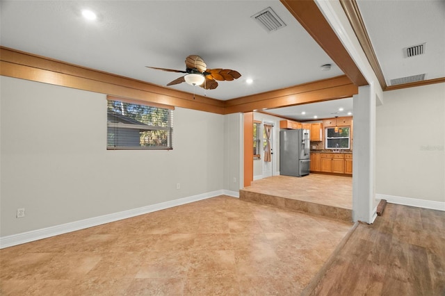 unfurnished living room with ceiling fan