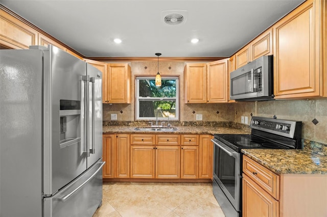 kitchen featuring sink, backsplash, dark stone counters, hanging light fixtures, and stainless steel appliances