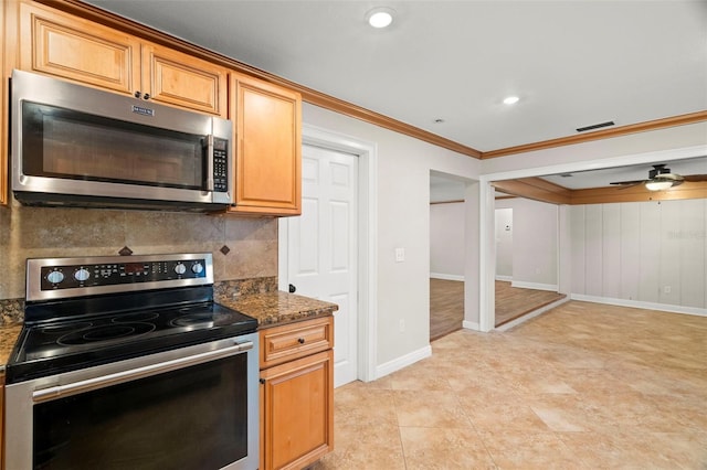 kitchen featuring ceiling fan, appliances with stainless steel finishes, tasteful backsplash, ornamental molding, and dark stone counters