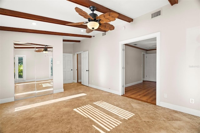 interior space with beam ceiling, a closet, and ceiling fan