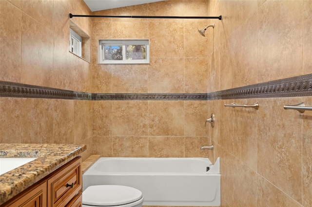 full bathroom with vanity, tiled shower / bath, and toilet