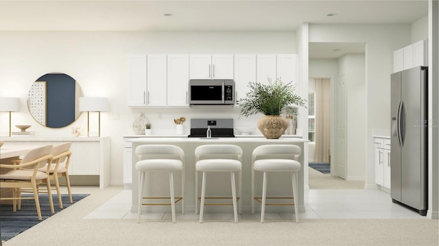 kitchen with stainless steel appliances, a kitchen island with sink, light tile patterned floors, and white cabinets