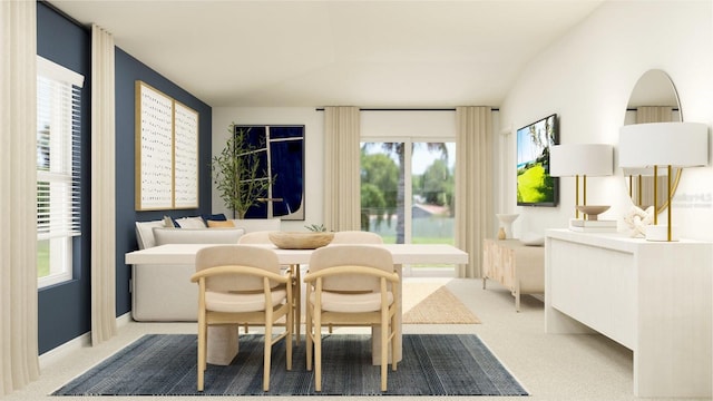 dining space with light carpet and vaulted ceiling