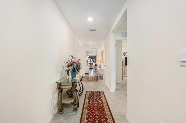 hall with light tile patterned floors