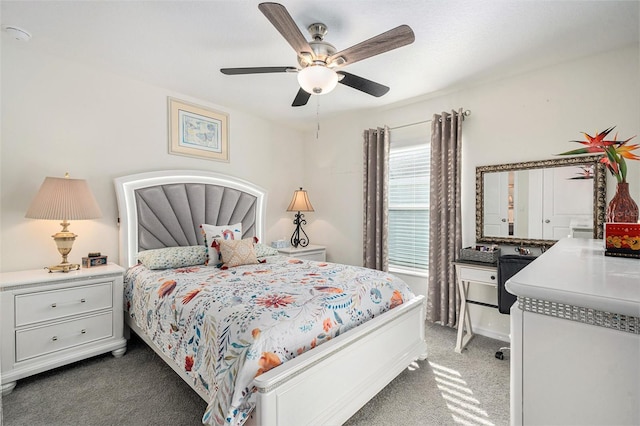 bedroom featuring ceiling fan and dark colored carpet