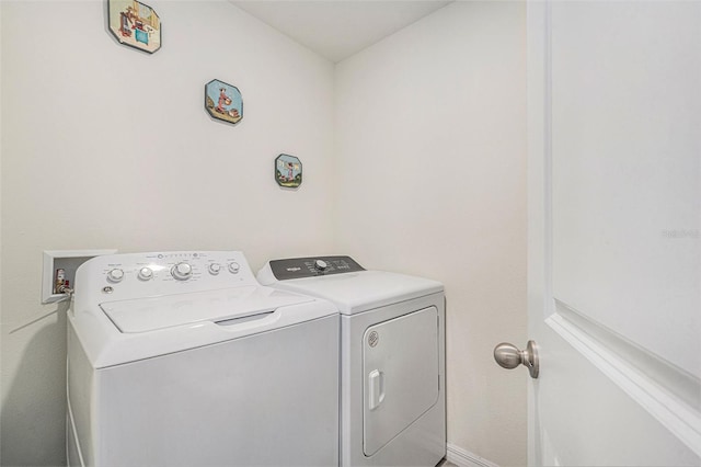 clothes washing area with washer and dryer