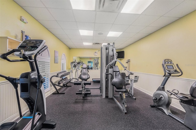 exercise room with a paneled ceiling