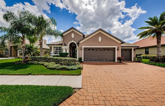 view of front of home featuring a garage and a front lawn