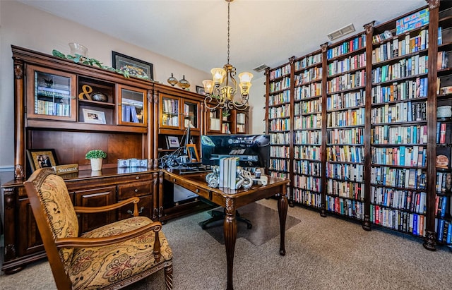 home office with an inviting chandelier and light carpet