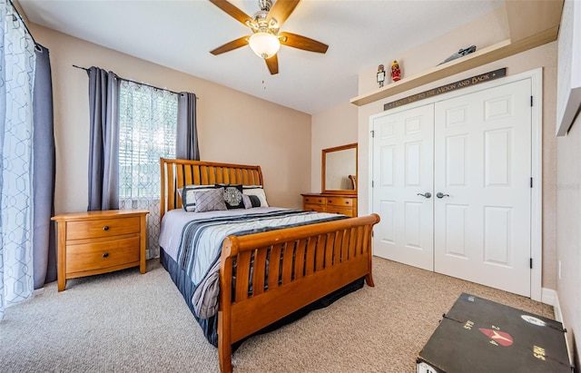 carpeted bedroom with lofted ceiling, ceiling fan, and a closet