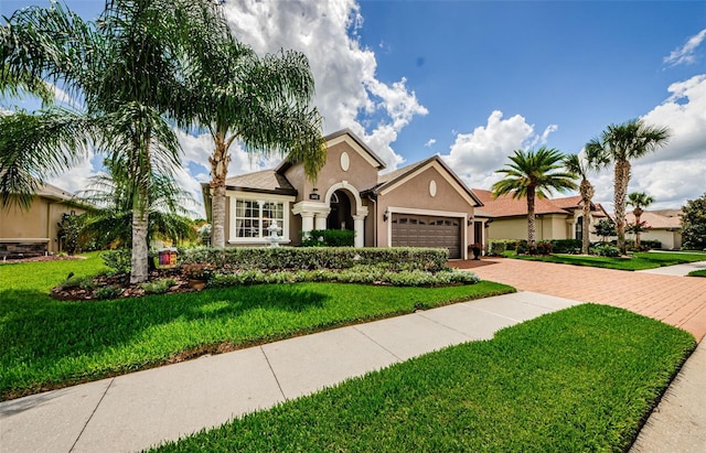 view of front of property featuring a garage and a front lawn