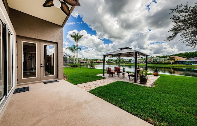 view of yard featuring french doors, a gazebo, a water view, and a patio