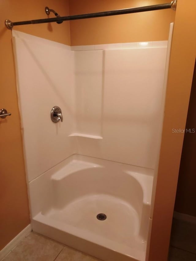 bathroom featuring tile patterned flooring and walk in shower