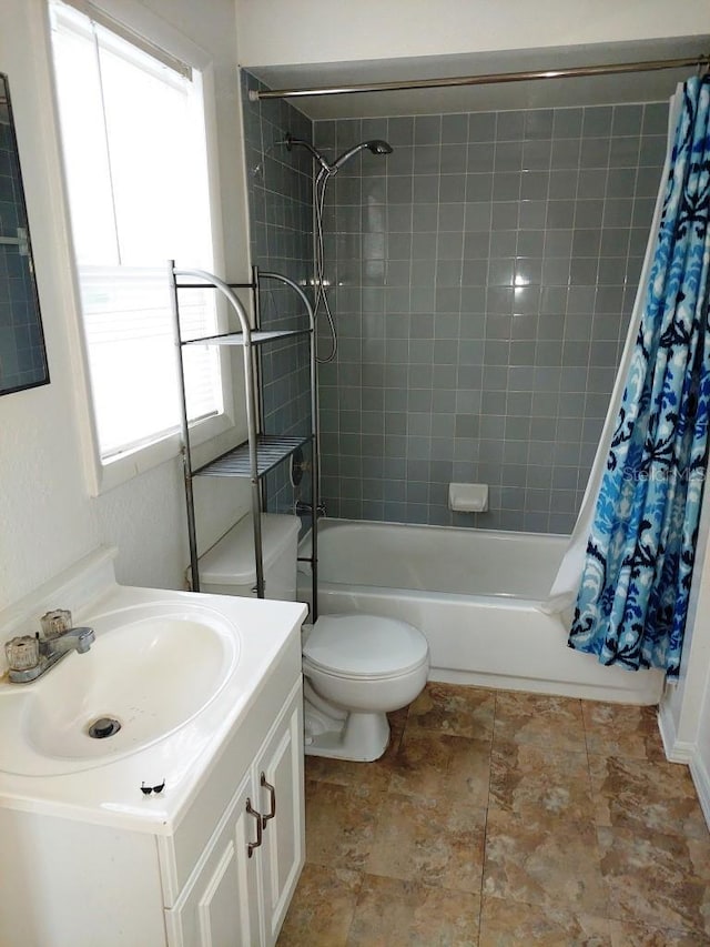 full bathroom featuring vanity, shower / bath combination with curtain, and toilet