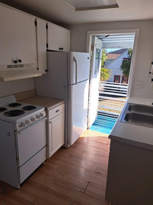 kitchen with white cabinetry, sink, white electric range, and wood-type flooring