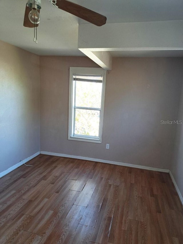 unfurnished room with dark hardwood / wood-style floors and ceiling fan