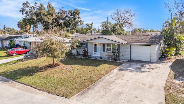 ranch-style home with a garage, a front yard, and central air condition unit