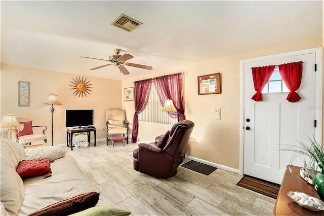 living room featuring ceiling fan and light hardwood / wood-style flooring