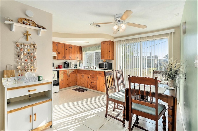 kitchen with range with electric cooktop, ceiling fan, extractor fan, and light tile patterned floors