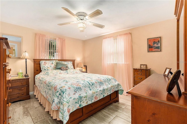 bedroom featuring multiple windows and ceiling fan