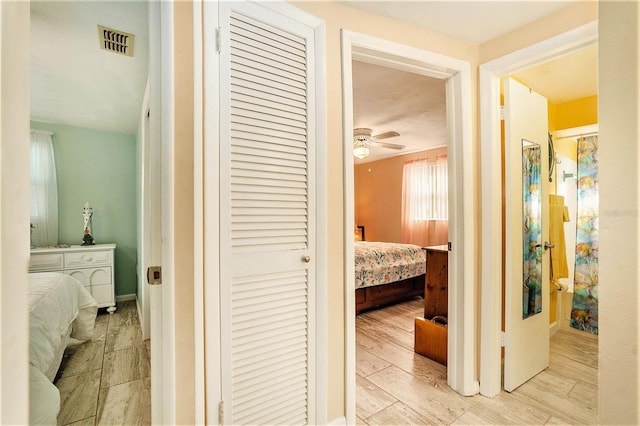 corridor with light hardwood / wood-style floors