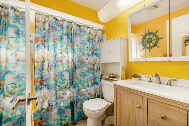 bathroom with walk in shower, vanity, and toilet