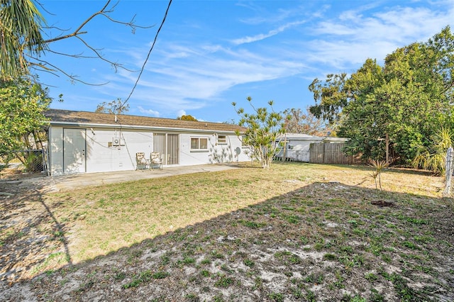 rear view of house with a yard and a patio area