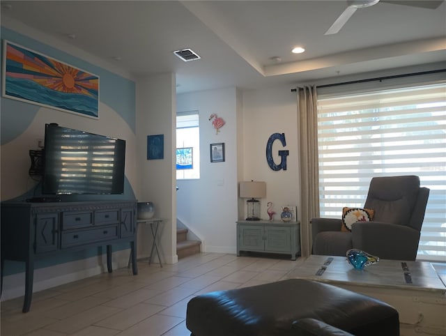 tiled living room with ceiling fan