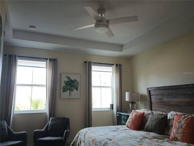 bedroom featuring ceiling fan and a tray ceiling