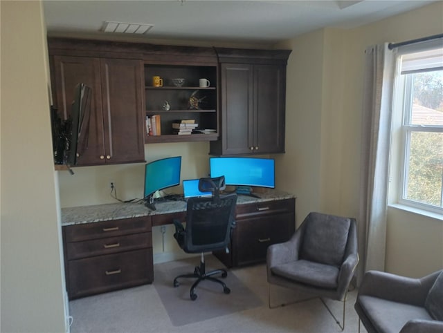 home office featuring built in desk and plenty of natural light