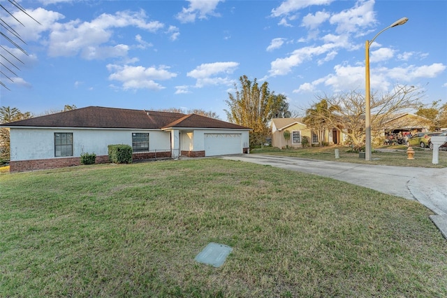 single story home featuring a garage and a front lawn