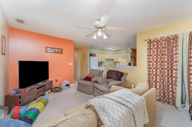 living room featuring ceiling fan and light colored carpet