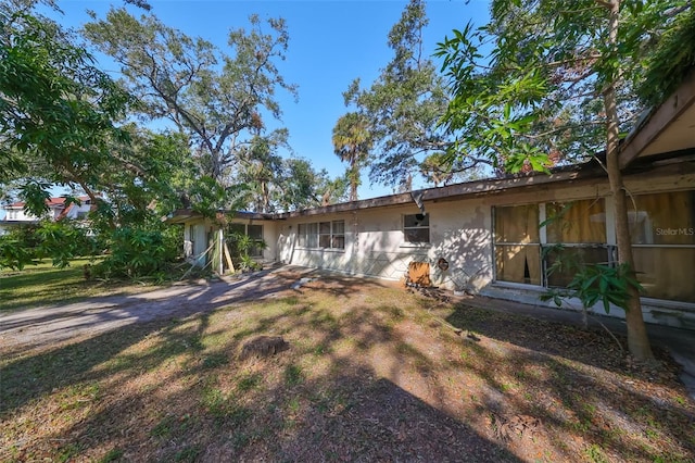 rear view of property with a lawn