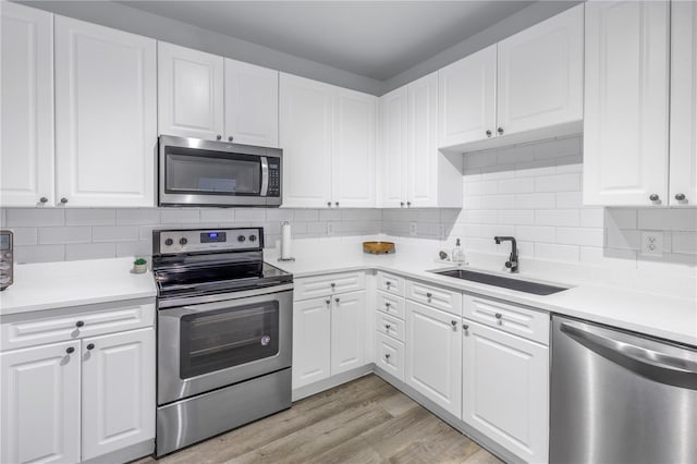 4221 W Spruce St Unit 1325, Tampa, FL 33607 - kitchen with white cabinetry, sink, and appliances with stainless steel finishes
