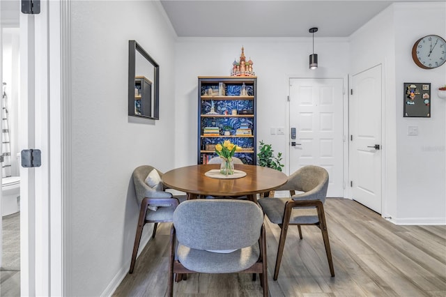 4221 W Spruce St Unit 1325, Tampa, FL 33607 - dining room with hardwood / wood-style flooring and crown molding
