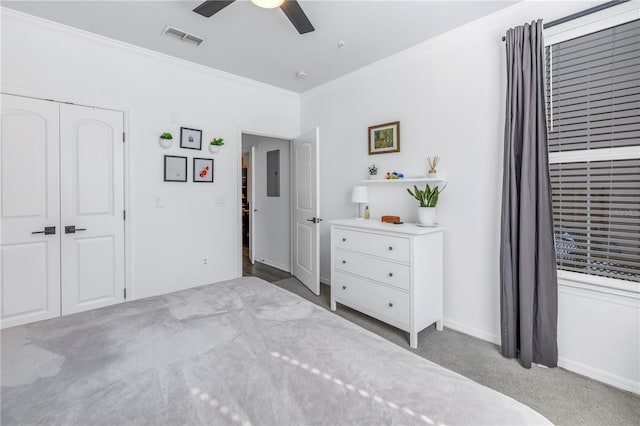 4221 W Spruce St Unit 1325, Tampa, FL 33607 - bedroom with crown molding, light colored carpet, ceiling fan, and a closet