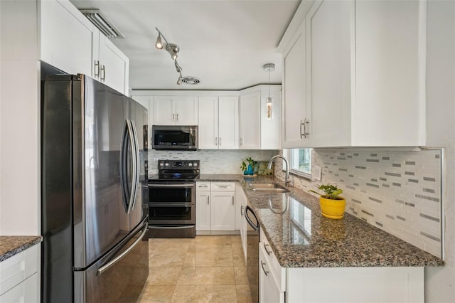 kitchen with sink, backsplash, stainless steel appliances, white cabinets, and dark stone counters