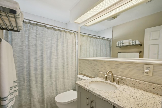 bathroom featuring vanity, curtained shower, backsplash, and toilet