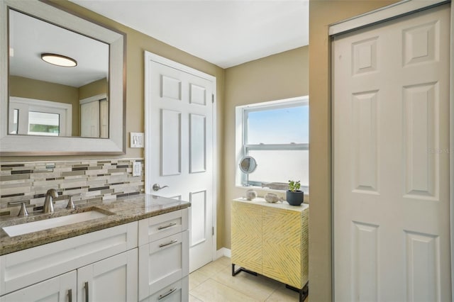 bathroom with vanity, tile patterned flooring, and backsplash