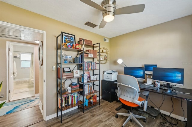 office with wood-type flooring and ceiling fan